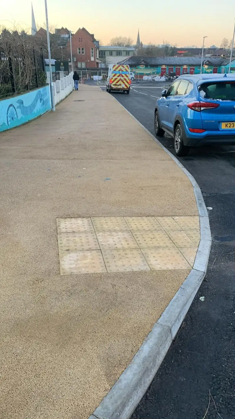 New footway with buff tactile paving at a pedestrian crossing point